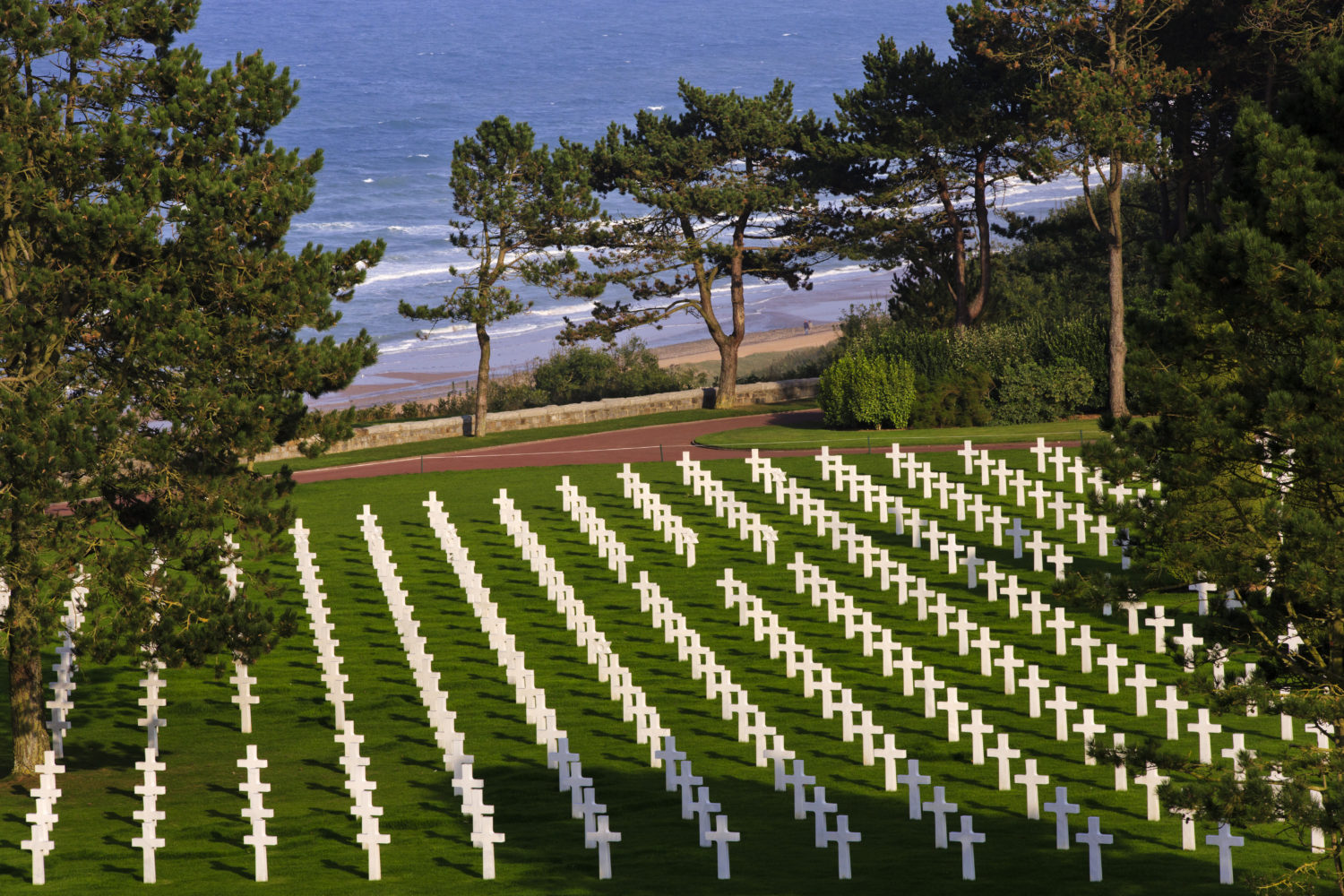 Graves of the fallen with Omaha Beach in the background at the Normandy American Cemetery and Memorial, September 27, 2013, Colleville-sur-Mer, France (Warrick Page/American Battle Monuments Commission) spectator.org