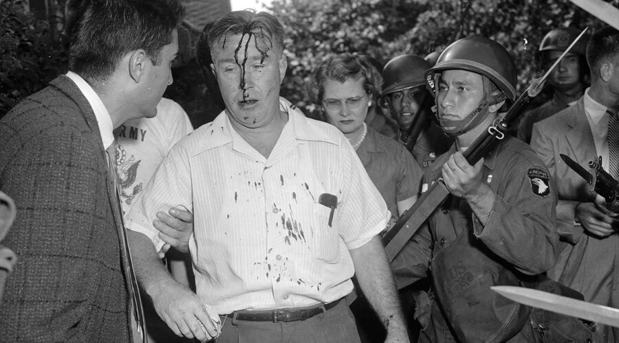 The 101st Airborne explaining school desegregation to a Little Rock protester.